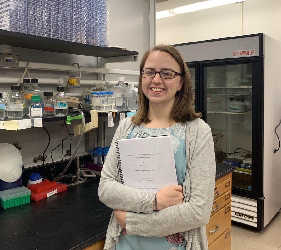 Shelby with her thesis and plaque assays